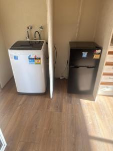 a small refrigerator and a sink in a room at Shaun place in Old Reynella