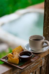 a plate of food and a cup of coffee on a table at Lembu Putih House in Tegalalang