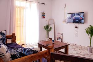 a living room with a couch and a table at Azara Watamu in Watamu