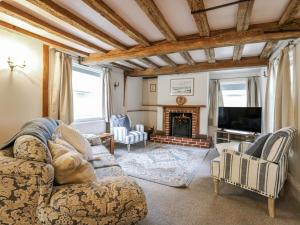 a living room with a couch and a fireplace at White Gates in Norwich