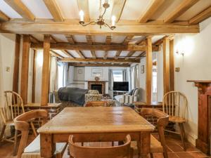 a dining room with a wooden table and chairs at White Gates in Norwich