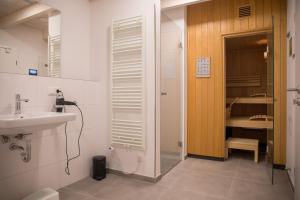 a bathroom with a sink and a mirror and a sink at Gulfhof Wangermeer 1 Lotta in Hohenkirchen +50 photos