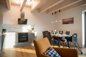 a kitchen and dining room with a table and chairs at Gulfhof Wangermeer 1 Lotta in Hohenkirchen