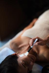a person brushing a mans face with a toothbrush at Irida Mindful Living - Adults Friendly 14 Plus in Agia Pelagia +85 photos