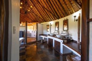 a bathroom with three sinks in a room at Tawi Lodge in Amboseli