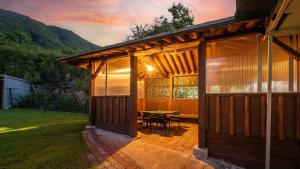 a house with a patio with a table in it at Gapyoeng New Cheongpyeong Pension in Gapyeong