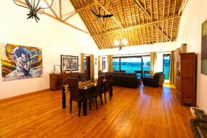a living room with a table and chairs and a couch at Tawi Lodge in Amboseli