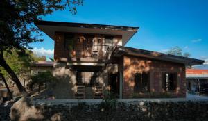 a rendering of a house with a stone wall at Aran Villas in Santa Maria