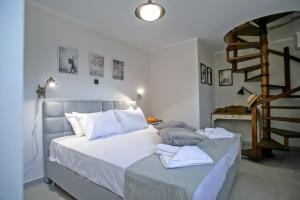 a bedroom with a bed with white sheets and a staircase at Casa Govino - Dolce fare niente in Danilia +53 photos