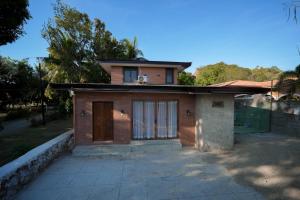 a small house with a dog sitting on top of it at Aran Villas in Santa Maria +17 photos