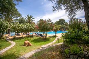 a large swimming pool with people in a park at Casa Govino - Dolce fare niente in Danilia