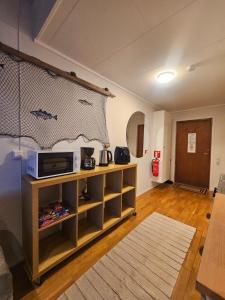 a living room with a tv on a wall at Fisher Loft 30 in Kristiansund