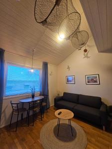 a living room with a couch and a table at Fisher Loft 30 in Kristiansund