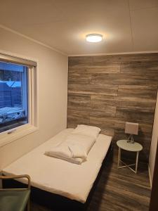 a small bedroom with a bed and a window at Fisher Loft 30 in Kristiansund