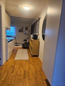 a room with a kitchen and a living room at Fisher Loft 30 in Kristiansund