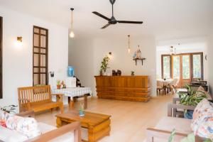 a living room with furniture and a ceiling fan at Surf Range in Matara