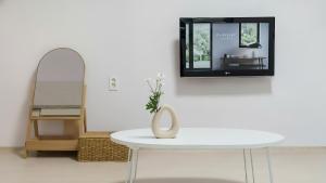 a white table in a room with a mirror at Boryeong (Daecheon) Jeil Pension in Boryeong