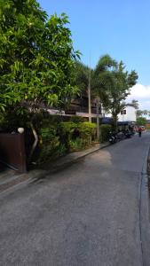 an empty street with trees on the side of a building at Myhomevillage in Ko Tao +3 photos