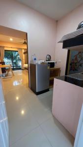 a kitchen with a stove and a counter in a room at Myhomevillage in Ko Tao