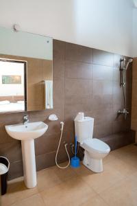 a bathroom with a toilet and a sink at Surf Range in Matara
