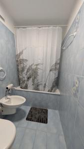 a bathroom with a sink and a toilet and a window at Ascona, Casa Collegio - im Zentrum, am See Lago Maggiore in Ascona +9 photos