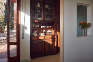 a wooden hutch with a vase of flowers in a hallway at Le Balze Appartamenti in Perugia