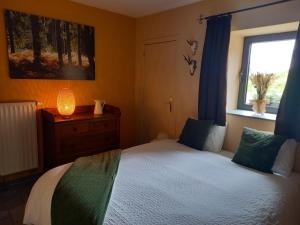 a bedroom with a bed and a window at Le Clos du Cerf - Le Sous-bois in Stoumont +32 photos