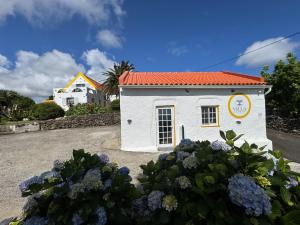 a small white building with a red roof at Villa Cedros in Santa Cruz das Flores +5 photos