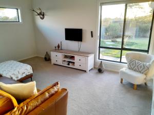 a living room with a couch and a tv at Luxury House Boho Seaside in Cowes