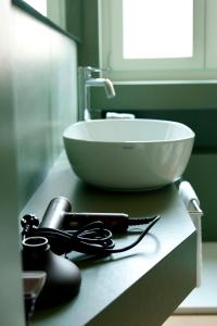 a white bowl on top of a sink on a counter at Suite Cecilia by Piazza del Lago, Como Center in Como +29 photos
