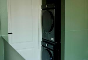 a black microwave oven in a kitchen at Suite Cecilia by Piazza del Lago, Como Center in Como