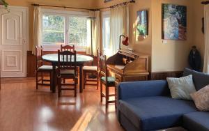 a living room with a couch and a table and chairs at La casa del pintor in Breña Alta +24 photos
