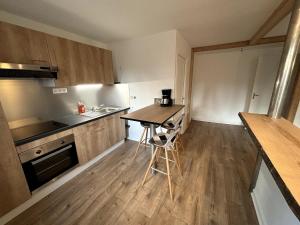 a small kitchen with a table and a counter at Le coeur du Velay 2 personnes in Le Puy-en-Velay