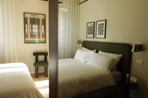 a bedroom with a bed and a mirror at Suite Cecilia by Piazza del Lago, Como Center in Como