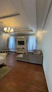 a living room with a couch and a tv at TULI VEER BAGH RESORT TURIA in Khawāsa
