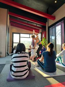 a group of people sitting on the floor watching a woman doing yoga at Villa Baraka in İznik