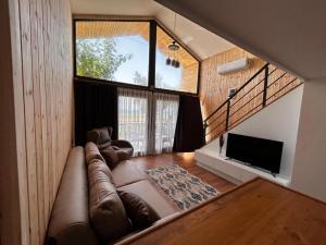 a living room with a large couch and a tv at Mavi Apart in Demre