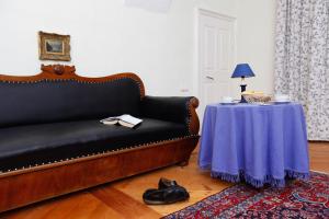 a living room with a couch and a table at Schloss Unterloibl in Ferlach