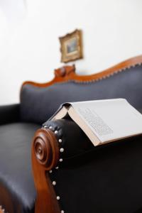 a book sitting on the seat of a couch at Schloss Unterloibl in Ferlach