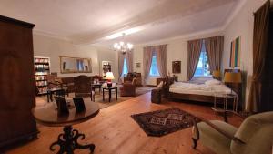 a large living room with a bed and a couch at Schloss Unterloibl in Ferlach
