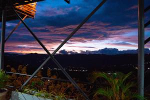 a sunset view from the balcony of a house at Serenity Busay Room 2 in Cebu City