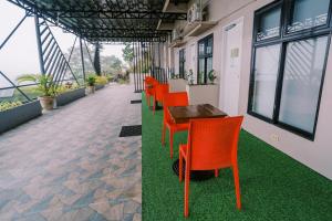 a row of orange chairs and a table in a building at Serenity Busay Room 2 in Cebu City