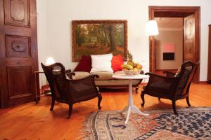 a living room with a couch and two chairs at Schloss Unterloibl in Ferlach