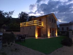 a building with lights on the side of it at Casale Parvil in Monteprandone