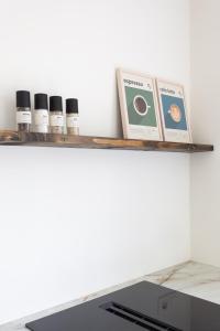 a shelf with five essential oils and a book at De Wilden Ezel in Mol