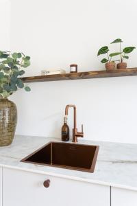 a kitchen with a copper sink on a counter at De Wilden Ezel in Mol