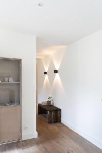 a living room with a table and a shelf at De Wilden Ezel in Mol