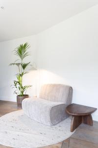 a white living room with a couch and a table at De Wilden Ezel in Mol +17 photos