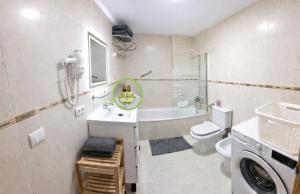 a bathroom with a sink and a toilet and a washing machine at Citadel Oliva 4p Roses, Beach & Centre, Private Parking, Terrace in Roses +17 photos