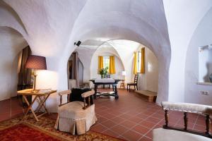 a living room with an archway and a table and chairs at Schloss Unterloibl in Ferlach +35 photos